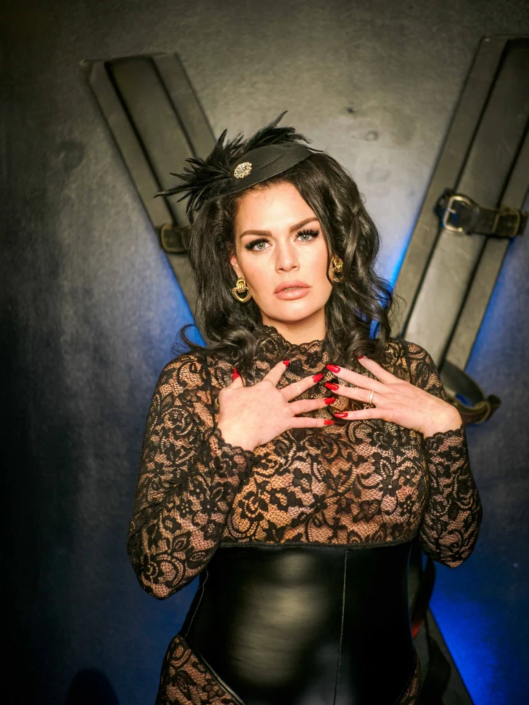 Mistress Charlotte O’Winter before a St Andrew’s cross, bondage mistress in London
