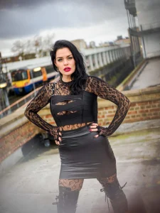 Mistress Charlotte O’Winter on a London rooftop above the railway, dominatrix in London
